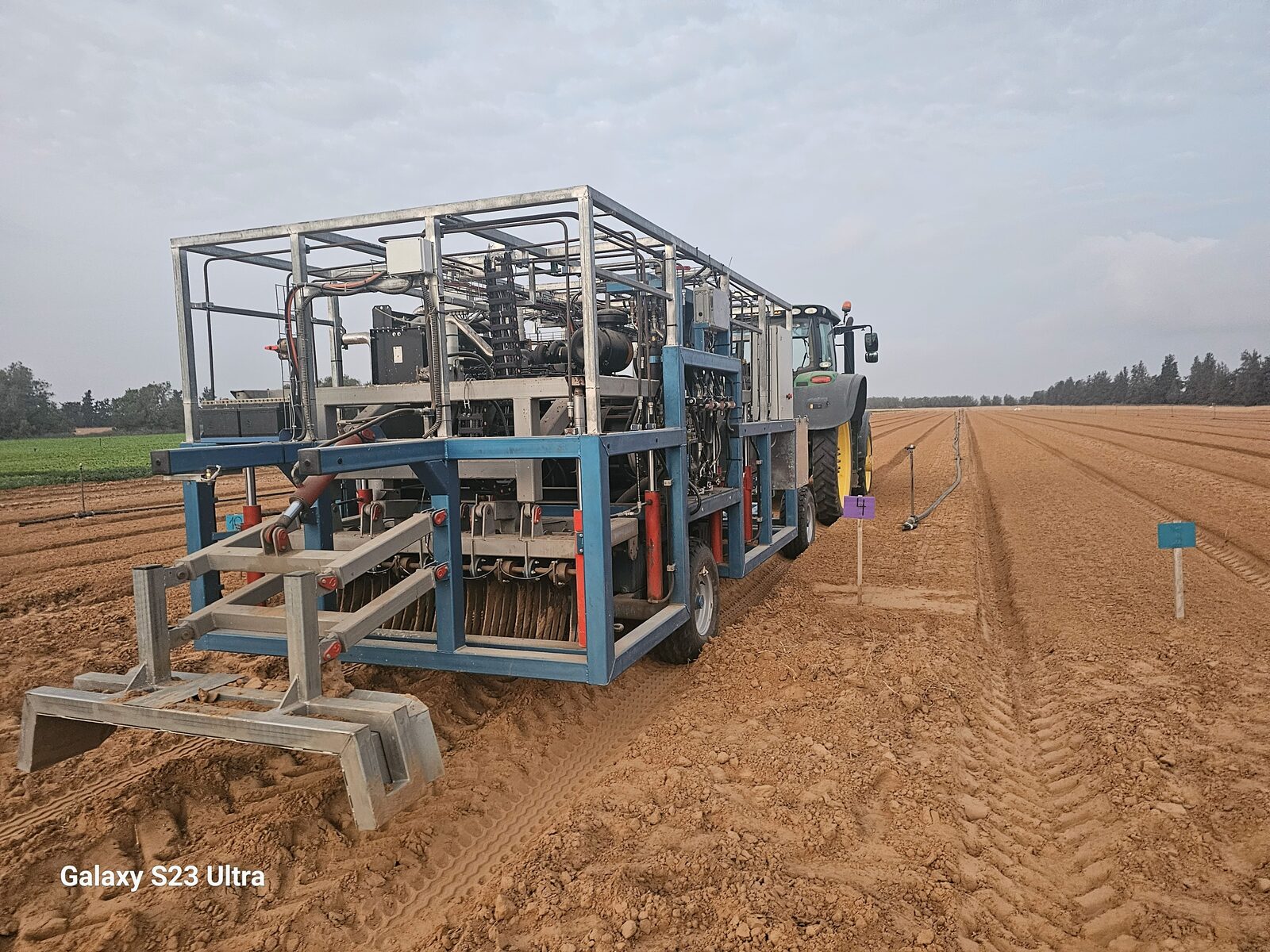 Clean Soil unit and tractor viewed from behind in a field