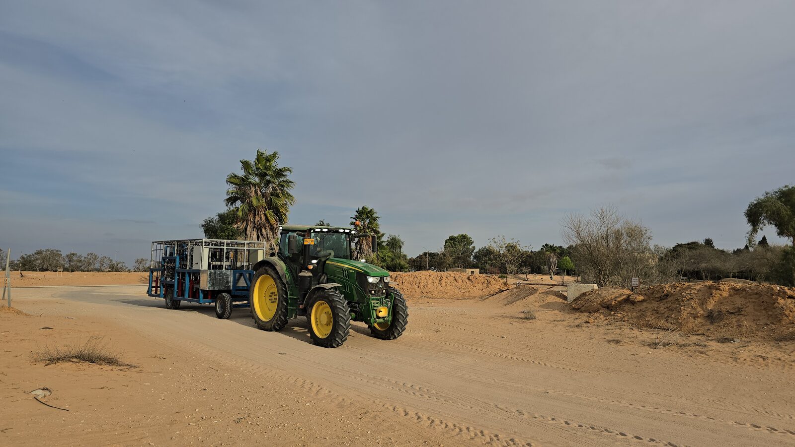 Tractor towing the Clean Soil unit to the field